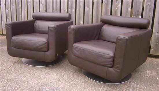 A pair of Natuzzi leather swivel armchairs W.77cm